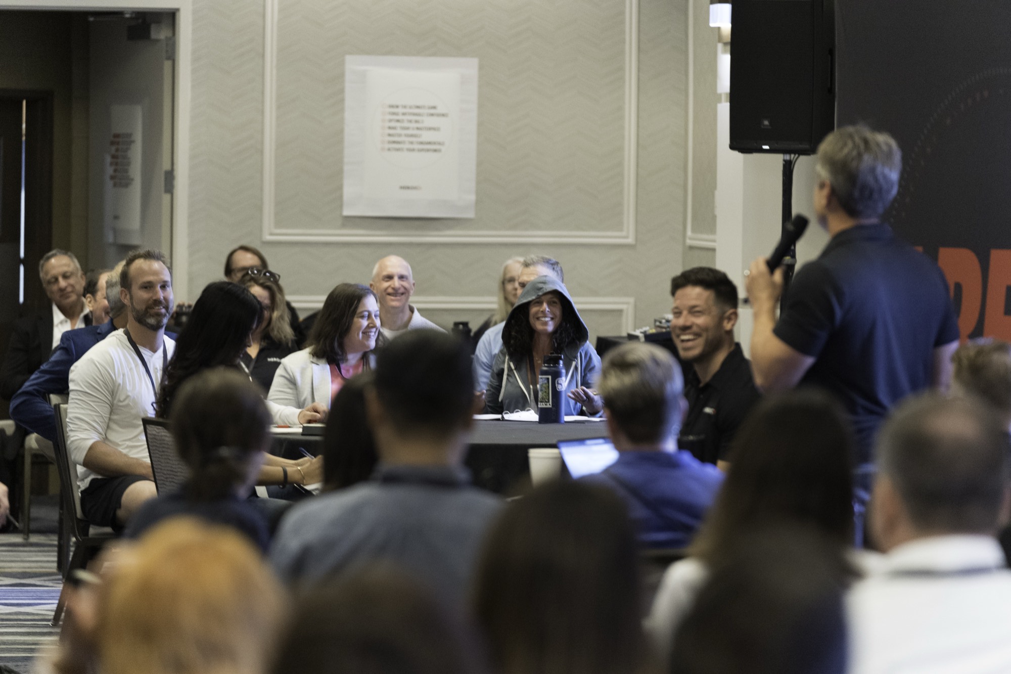 A room of professionals in a live Heroic session, laughing at something the speaker said